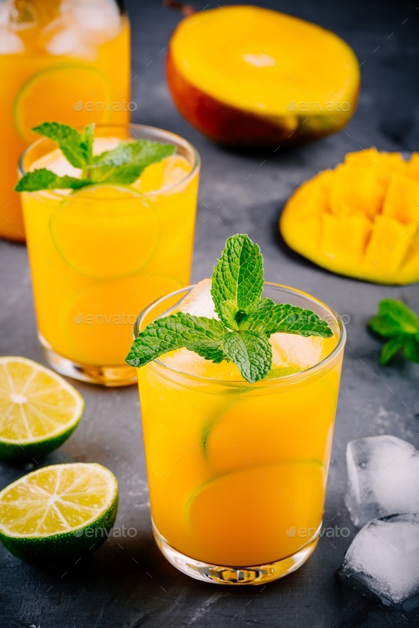 Fresh summer mango cocktail with lime and mint Stock Photo by nblxer