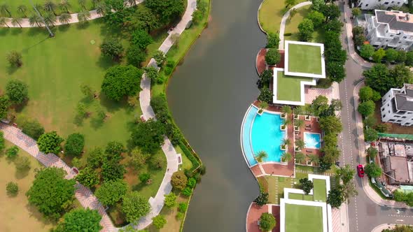 Aerial Flight of a Drone on a Bright Sunny Summer Day Against the Backdrop of a Beautiful Park and alt