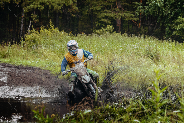 Man Motorcycle Racing Enduro in Forest