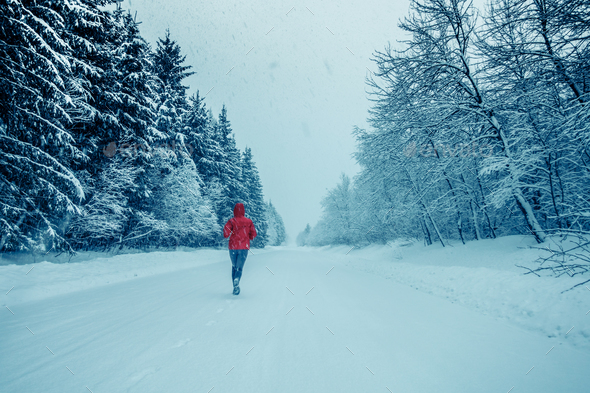 Woman Running Alone with Motion Blur during Cold Snowy day of Wi