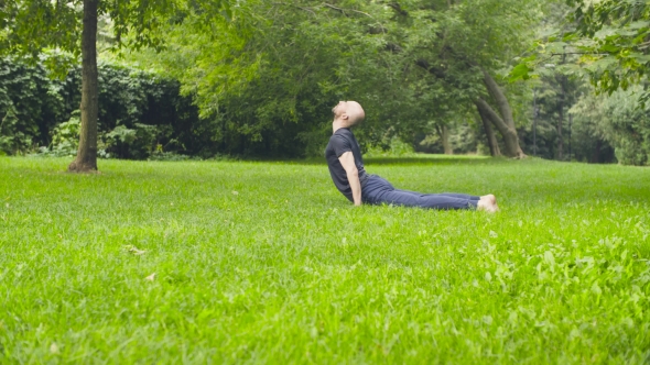 A Man Doing Yoga Exercises in the Park
