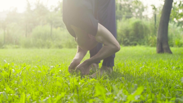 A Man Doing Yoga Exercises in the Park