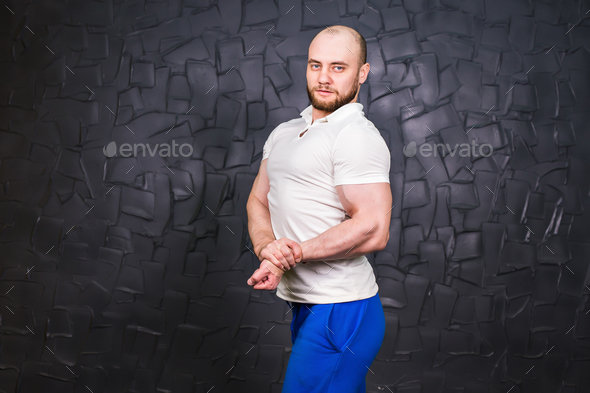 Personal Trainer Strong Guy Standing. Copyspace And Flexing Muscles. Muscular Athletic Man Posing