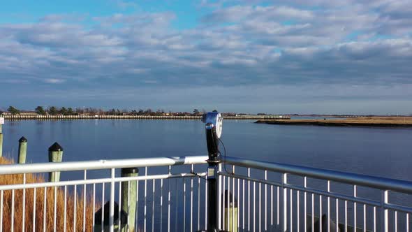 A low angle shot on the boardwalk facing the railings & pylons. It was taken during a gorgeous day. alt
