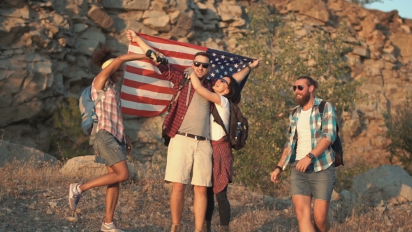 Excited Travelers Posing with Flag alt