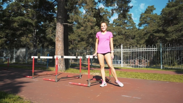 Professional Female Hurdler in Action. Running with Obstacles, Training