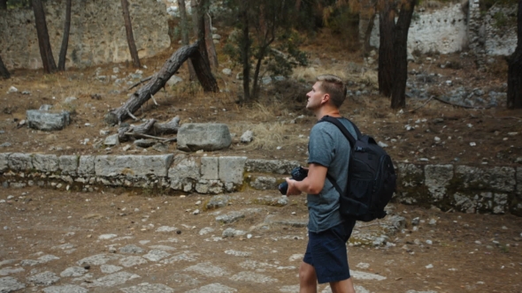 Traveler Photographer in the Ruins of the Antique City