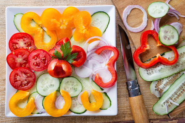 Salad of raw vegetables and ingredients with a knife - Stock Photo - Images