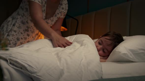 Child Little Baby Boy Sleeps Sweetly in His Crib and Smiles in His Sleep alt