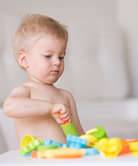 Boy playing with colorful modeling clay (plasticine or dough)