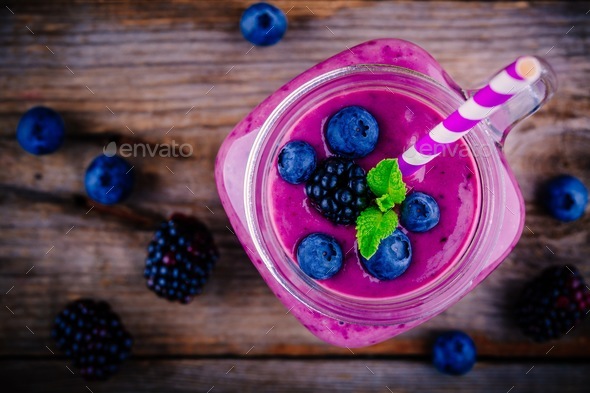 juicy blackberry smoothies in glass bottles Stock Photo by nblxer
