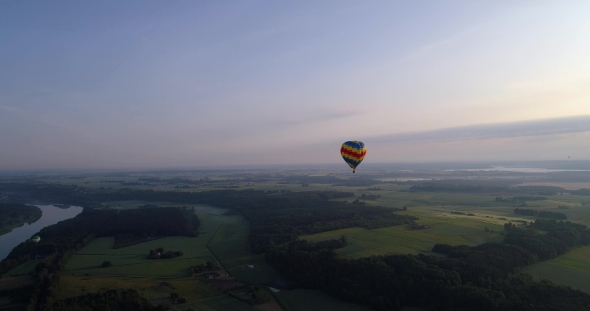 Air Baloon Over Green Lands at Early Mornig