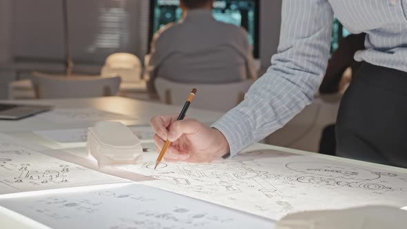 Unrecognizable Female Engineer Working on Blueprints alt