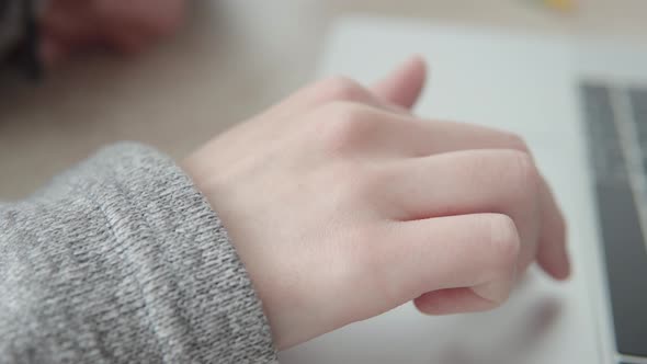 Close Up of Female Hand Uses the Trackpad of the Modern Laptop with Special Multitouch Gestures