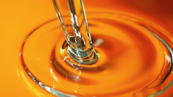 Super Slow Motion Shot of Pouring Golden Gel Liquid alt