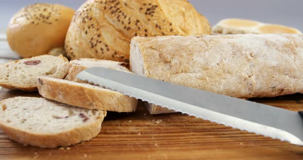Various bread loaves with knife alt