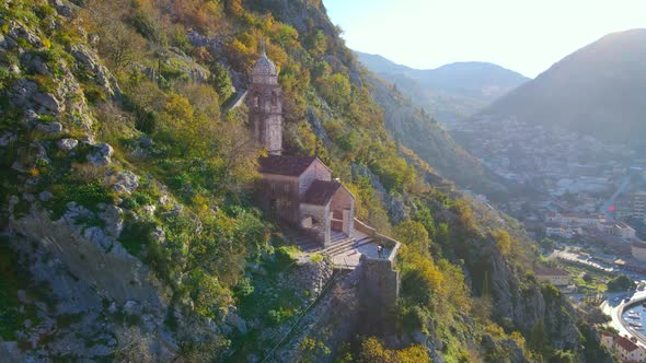 Aerial Shot of the Christian Church on a Way to the Top of the Mountain Where St alt