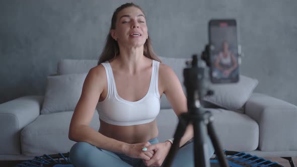 Sports Woman Trainer Sits in Front of the Camera Making Vlog