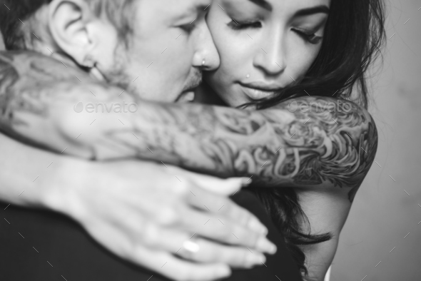 Beautiful, young couple posing on camera indoors - Stock Photo - Images