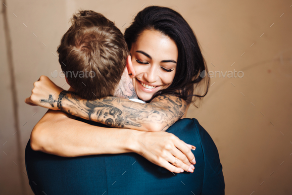 Beautiful, young couple posing on camera indoors - Stock Photo - Images
