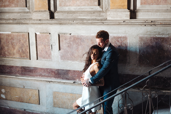 Beautiful, young couple posing on camera indoors - Stock Photo - Images