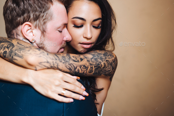 Beautiful, young couple posing on camera indoors - Stock Photo - Images