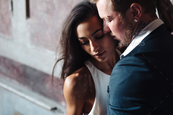 Beautiful, young couple posing on camera indoors - Stock Photo - Images