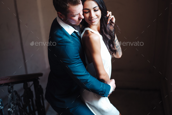 Beautiful, young couple posing on camera indoors - Stock Photo - Images