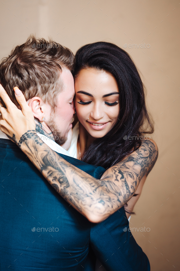 Beautiful, young couple posing on camera indoors - Stock Photo - Images