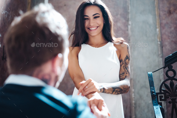 Beautiful, young couple posing on camera indoors - Stock Photo - Images