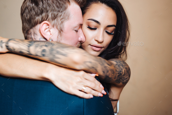 Beautiful, young couple posing on camera indoors - Stock Photo - Images