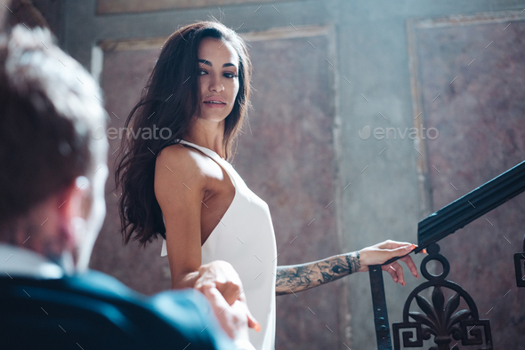 Beautiful, young couple posing on camera indoors - Stock Photo - Images