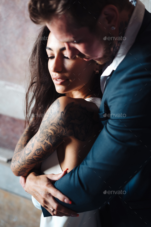 Beautiful, young couple posing on camera indoors - Stock Photo - Images