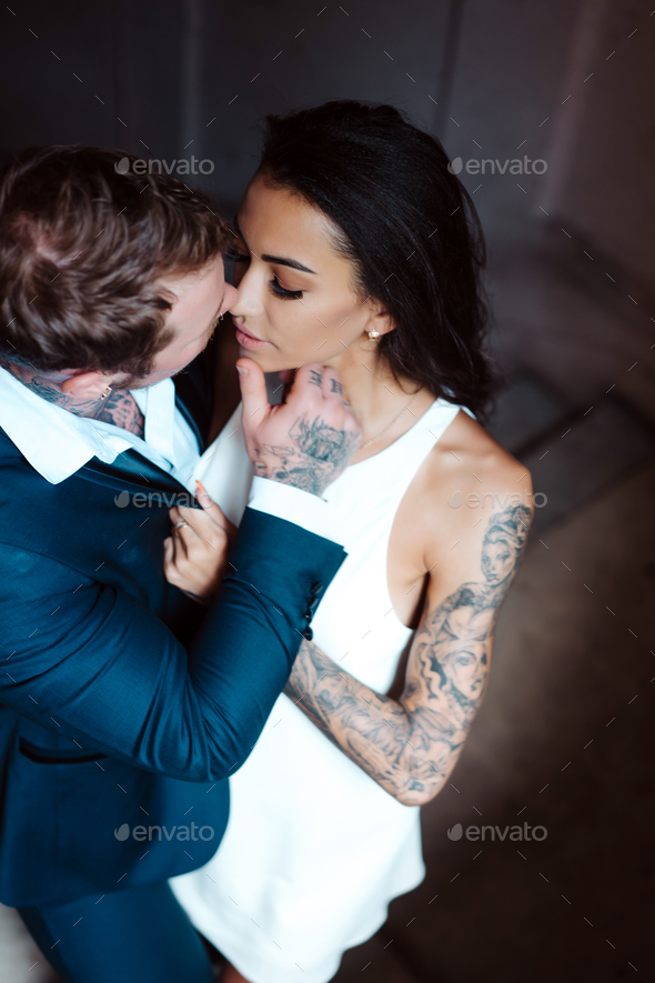 Beautiful, young couple posing on camera indoors - Stock Photo - Images