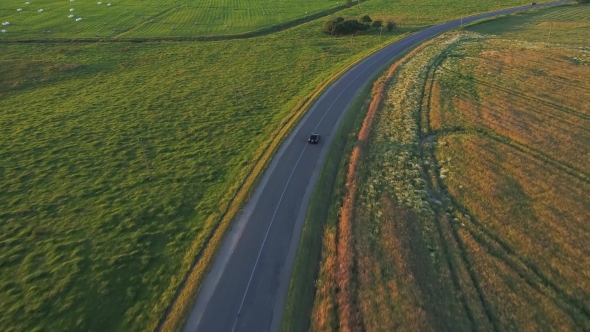 Aerial View of Sport Car Driving in Fields