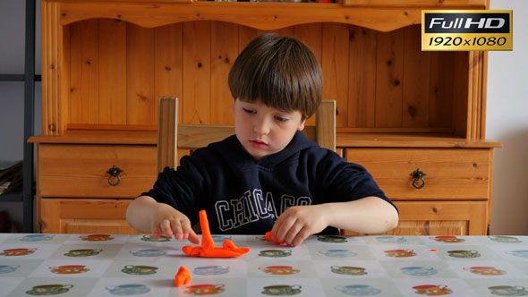 Child Modeling Orange Clay alt
