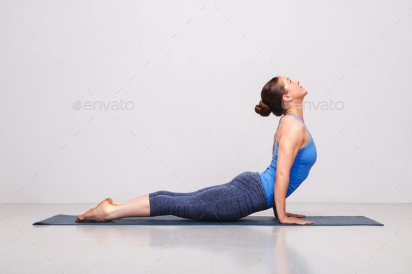 Woman doing Ashtanga Vinyasa yoga Sun Salutation asana Urdhva mu