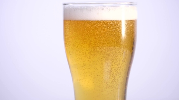 Glass of Beer Emptying on White Background