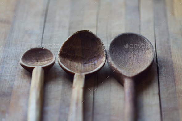 three kitchen wooden spoons on wooden board - Stock Photo - Images