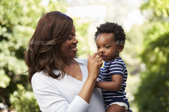 Outdoor Head And Shoulders Shot Of Mother Holding Son