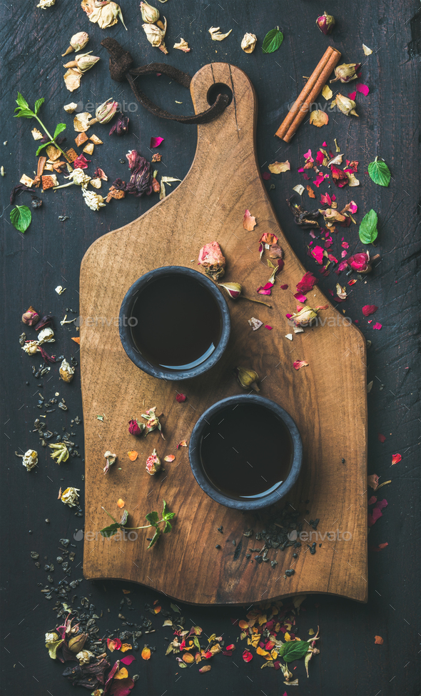 Chinese black tea in black stoneware cups on wooden board - Stock Photo - Images