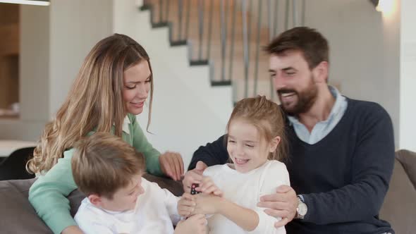 Happy family with two kids enjoy time together on couch in living room