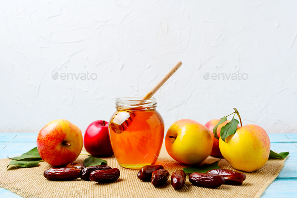 Honey jar, dates and ripe apples on burlap napkin - Stock Photo - Images