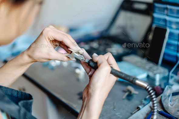 The girl is engaged in jewelry business Stock Photo by simbiothy | PhotoDune