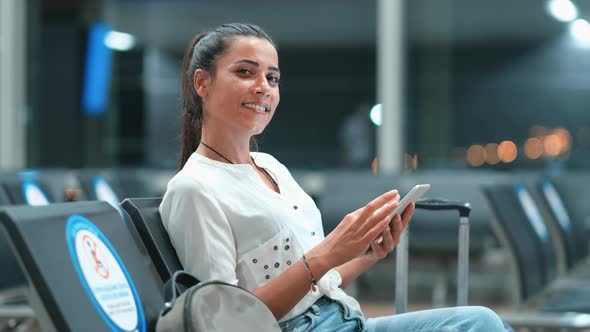 Woman Looking at Camera at Airport alt