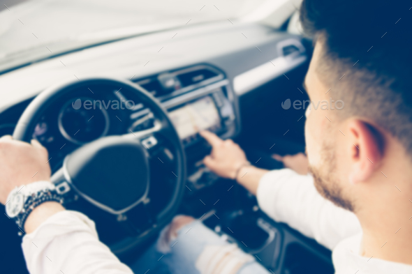 Young man is using the automotive navigation system