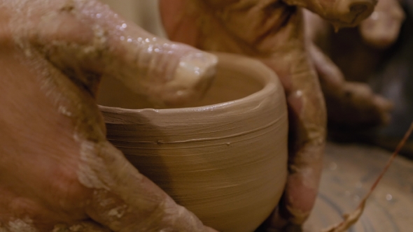 Potter Is Making Clay Pot on the Potter's Wheel alt