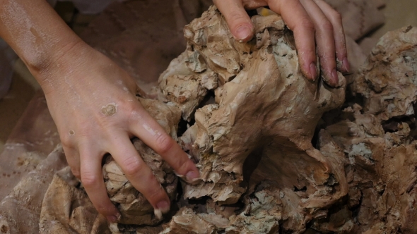 Sculptor Is Pugging Clay for Creating Pottery