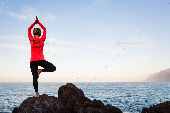 Woman meditating in yoga vrksasana tree pose