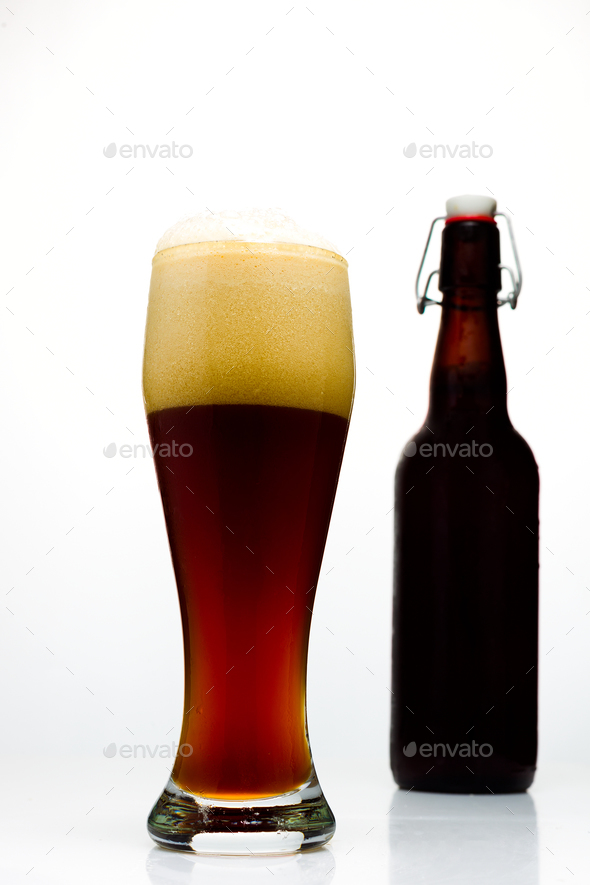 Dark beer in a glass and a bottle of beer on a white background